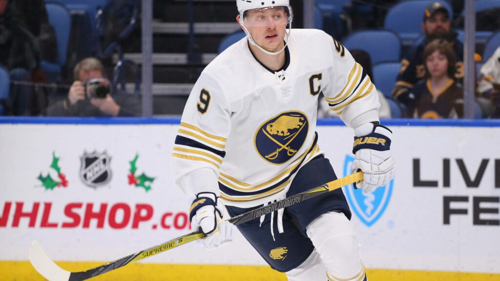 Jack Eichel Buffalo Sabres in white navy gold uniform focused intense gameplay action on ice Wallpaper