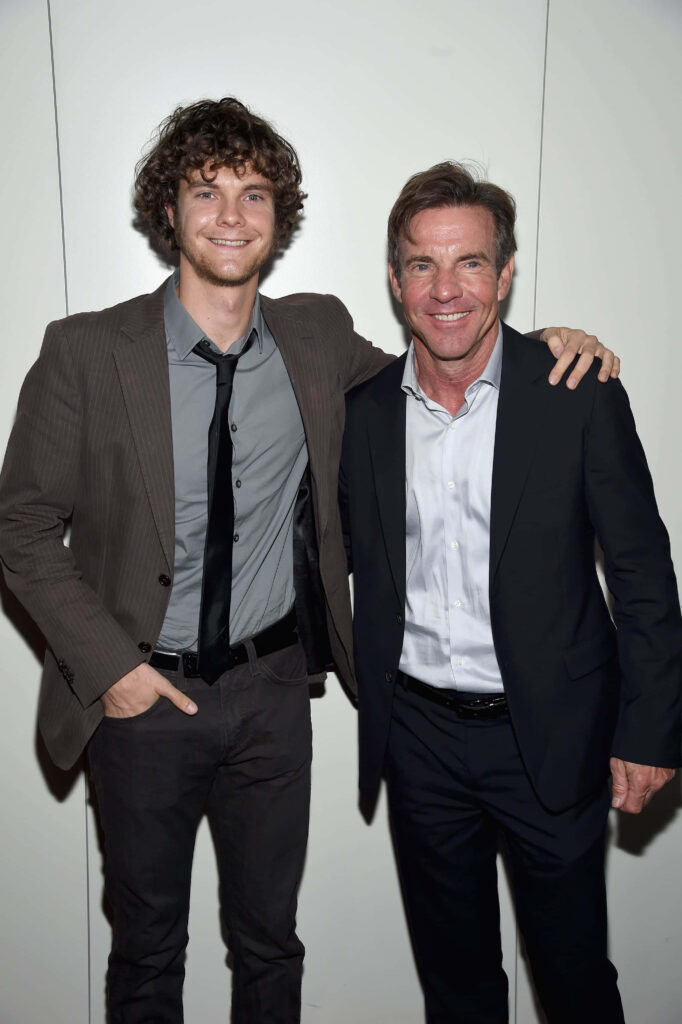 Jack Quaid and Dennis Quaid in stylish suits smiling against white background high-resolution wallpaper