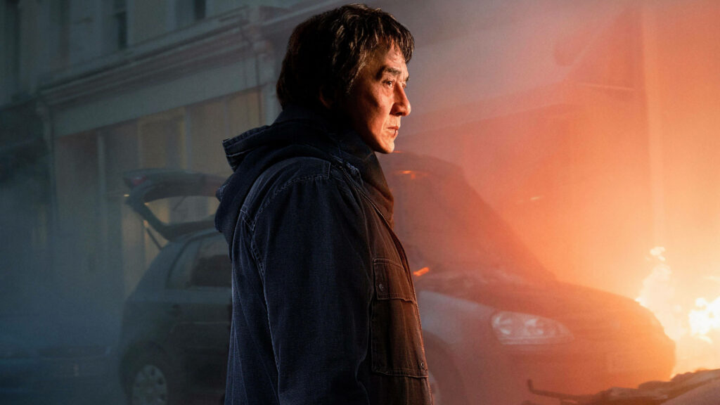 Jackie Chan deep in thought lit by warm firelight dramatic intense wallpaper background