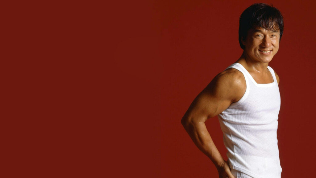 Jackie Chan confident in white tank top on red background dynamic energetic wallpaper