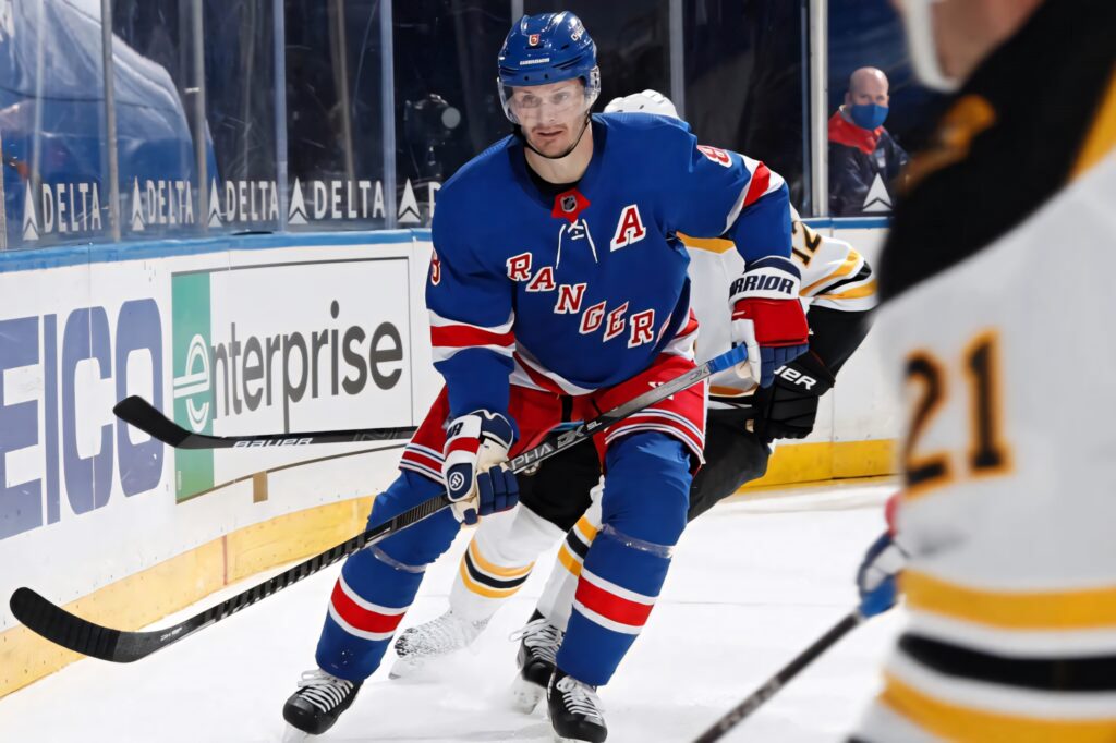 Jacob Trouba Winnipeg Jets in action intense NHL game versus Boston Bruins vibrant uniforms Wallpaper