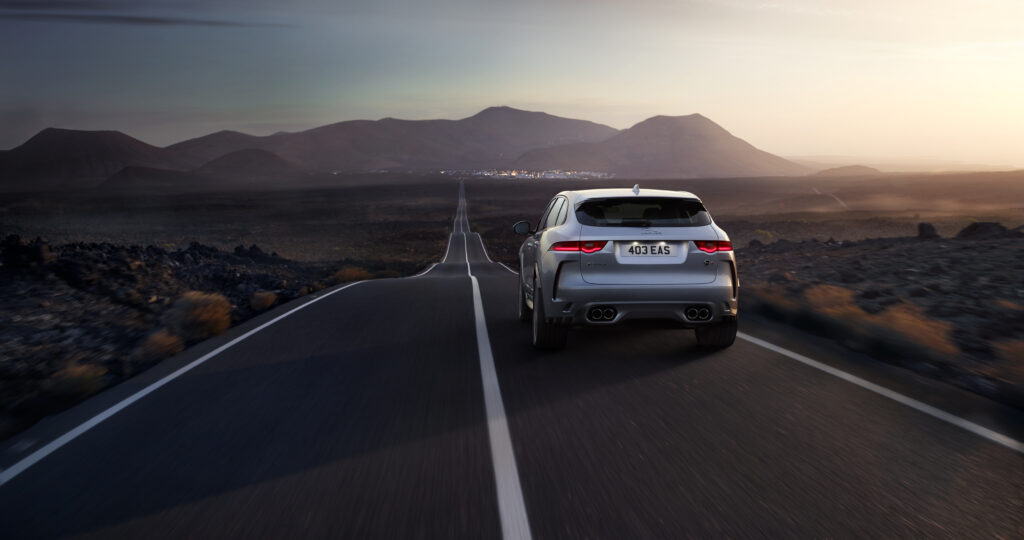 Jaguar F-Pace SVR Rear View: Scenic Open Road Adventure Wallpaper