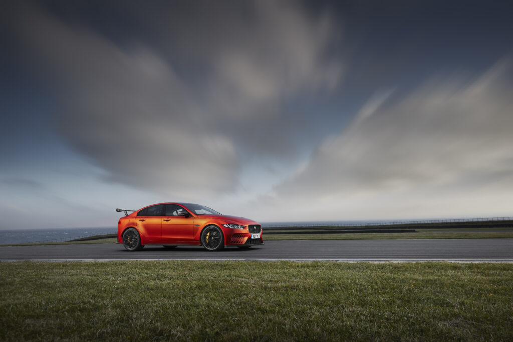 Jaguar XE SV Project 8: Stunning Side View Against Dramatic Sky Wallpaper