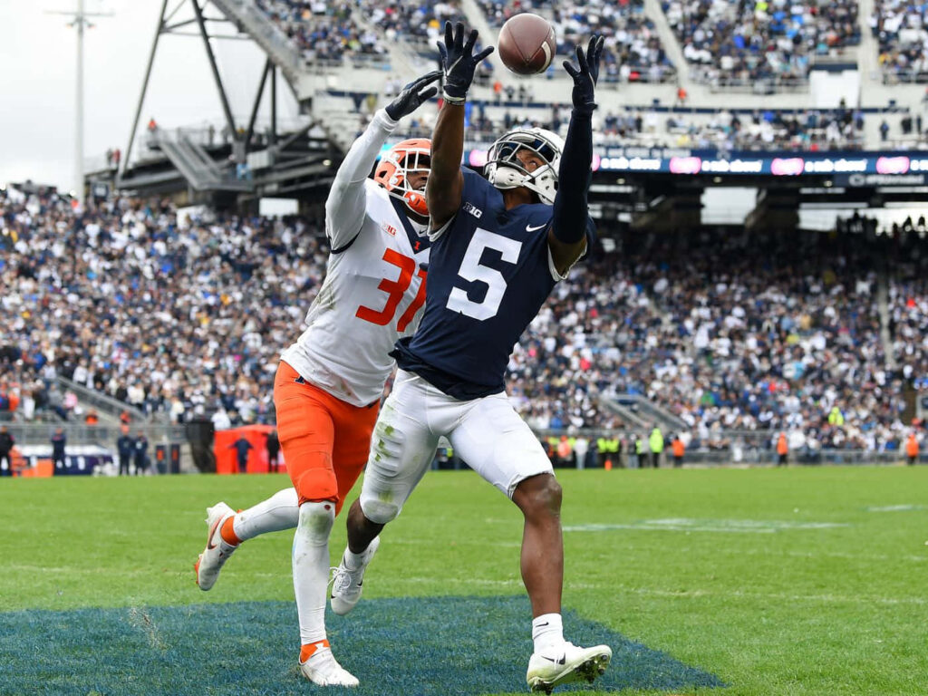 Penn State receiver Jahan Dotson makes overtime catch defended by Illinois Devon Witherspoon in packed stadium Wallpaper