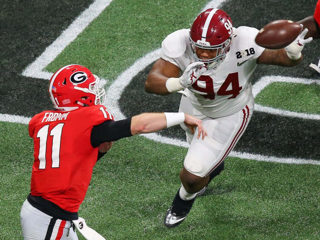 Jake Fromm in red Georgia jersey prepares to throw as Alabama defender Daron Payne rushes him Wallpaper