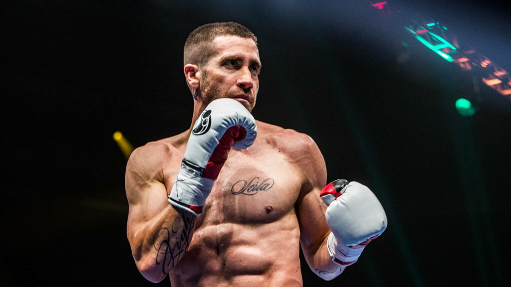 Jake Gyllenhaal shirtless in boxing ring wearing gloves focused intense expression wallpaper