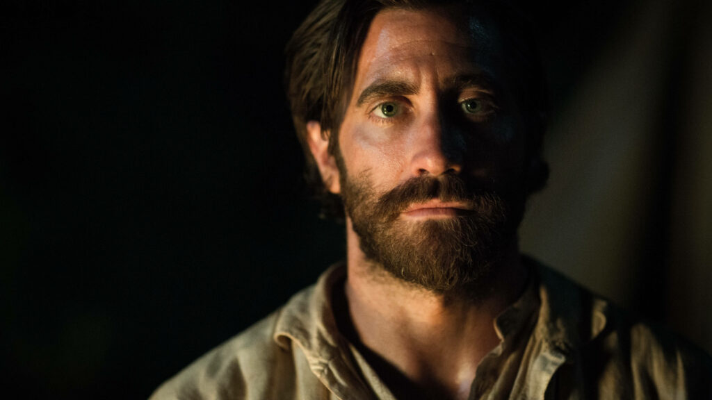 Jake Gyllenhaal intense close-up as The Sisters Brothers character dark background wallpaper