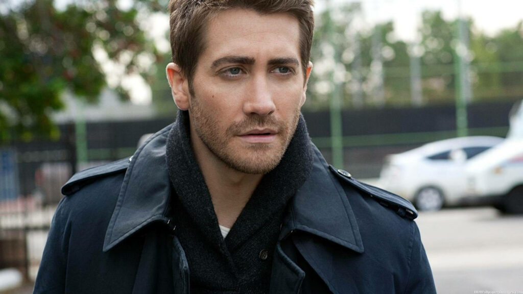 Jake Gyllenhaal outdoors cityscape wearing dark coat and scarf contemplative expression wallpaper