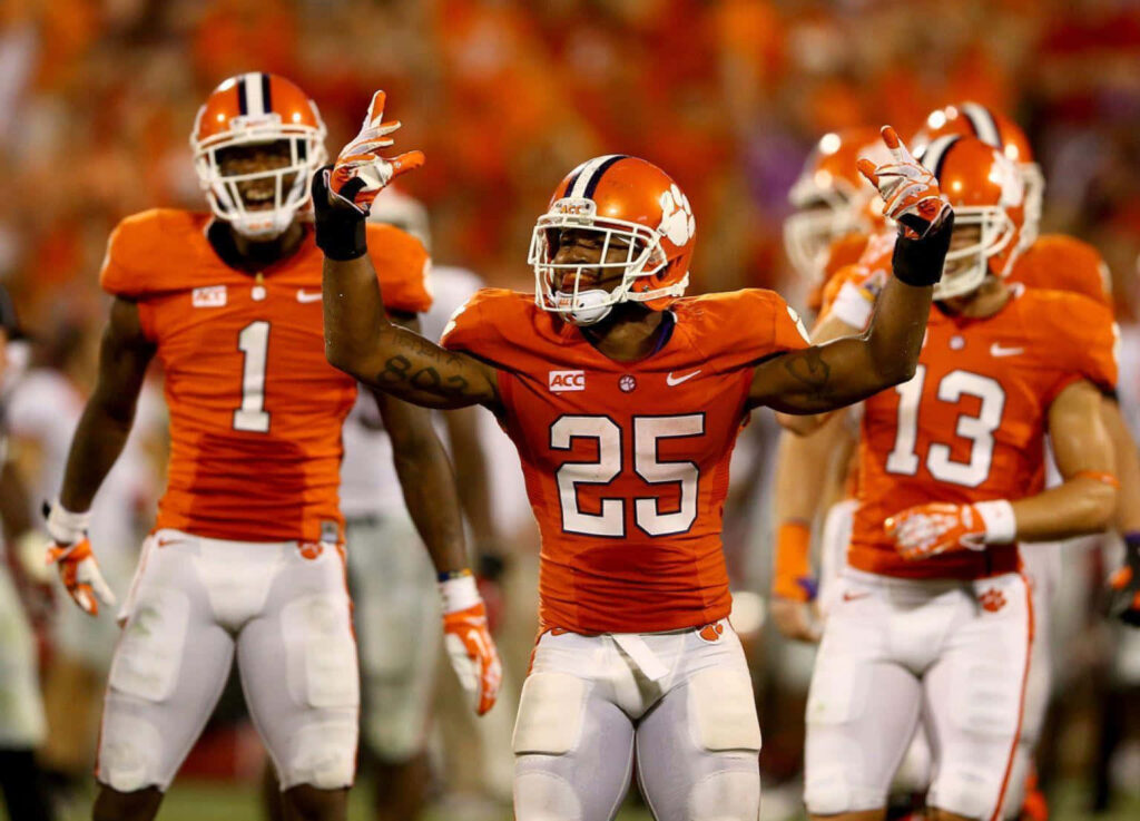 Jalyn Phillips Clemson Tigers football player in orange uniform action stadium wallpaper background