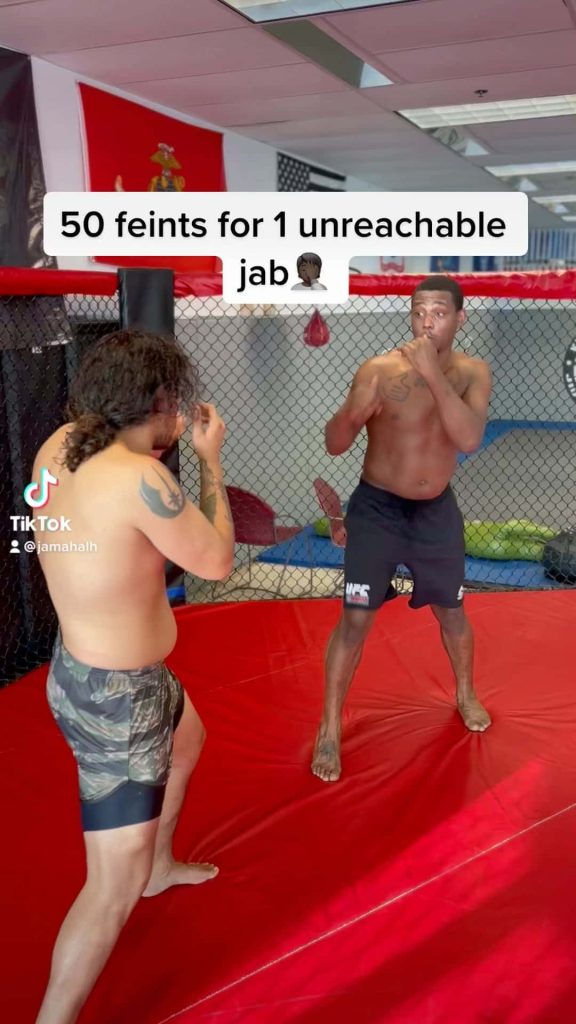 UFC fighter Jamahal Hill training intensely in gym cage MMA sparring session wallpaper