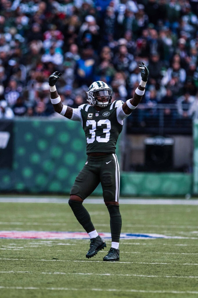 Jamal Adams Celebrates on Field: Energizing Jets Wallpaper Background