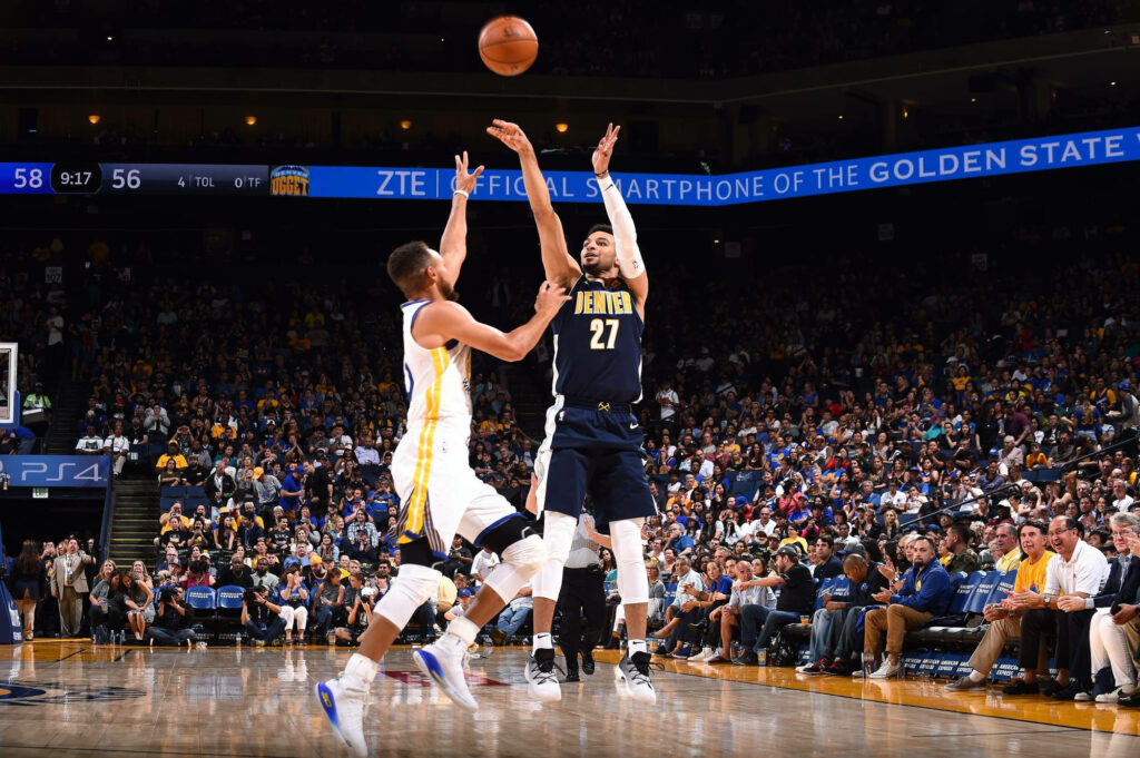 Jamal Murray Denver Nuggets mid-air shot over Golden State Warriors defender intense NBA game Wallpaper