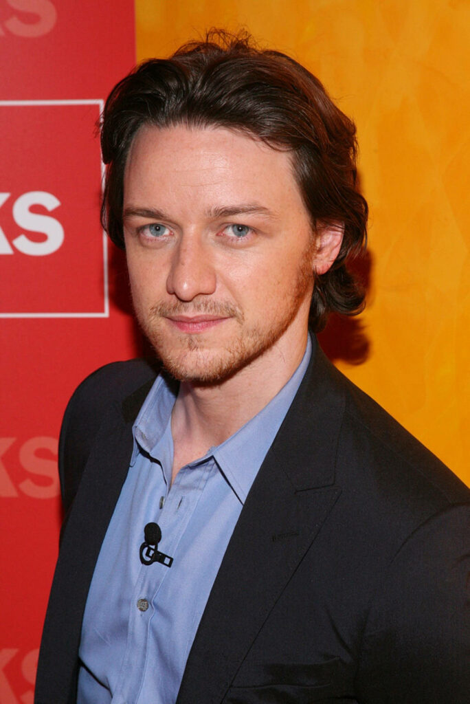 Scottish actor James McAvoy in sharp suit posing confidently at 39TimesTalks vibrant event backdrop Wallpaper