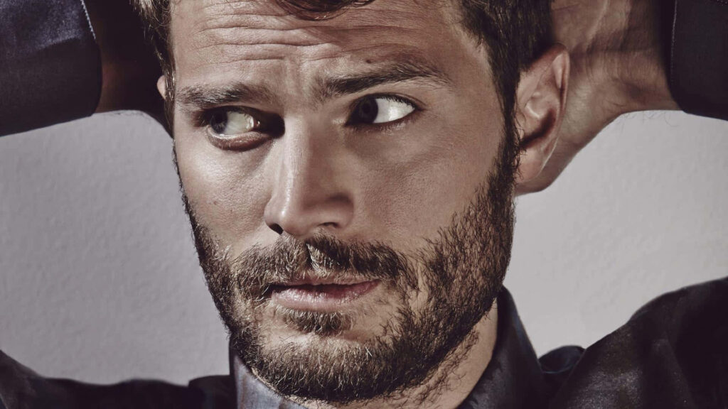 Jamie Dornan close up portrait intense gaze rugged charm simple wallpaper background
