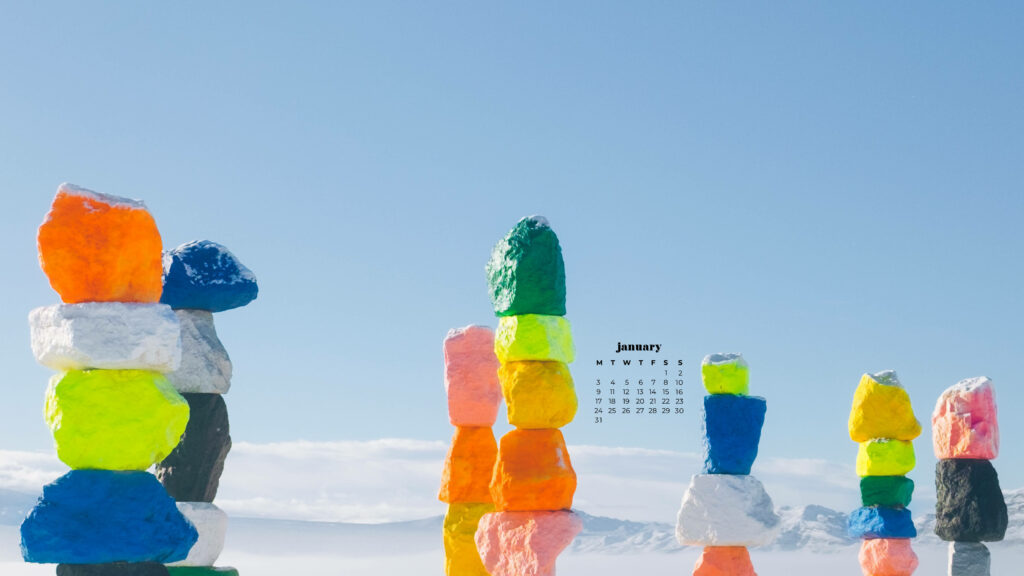 January 2022 calendar wallpaper with colorful stacked rocks and serene sky minimalist background