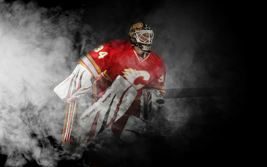 Jarome Iginla Calgary Flames No 34 in red gold gear emerging from smoke intense wallpaper background