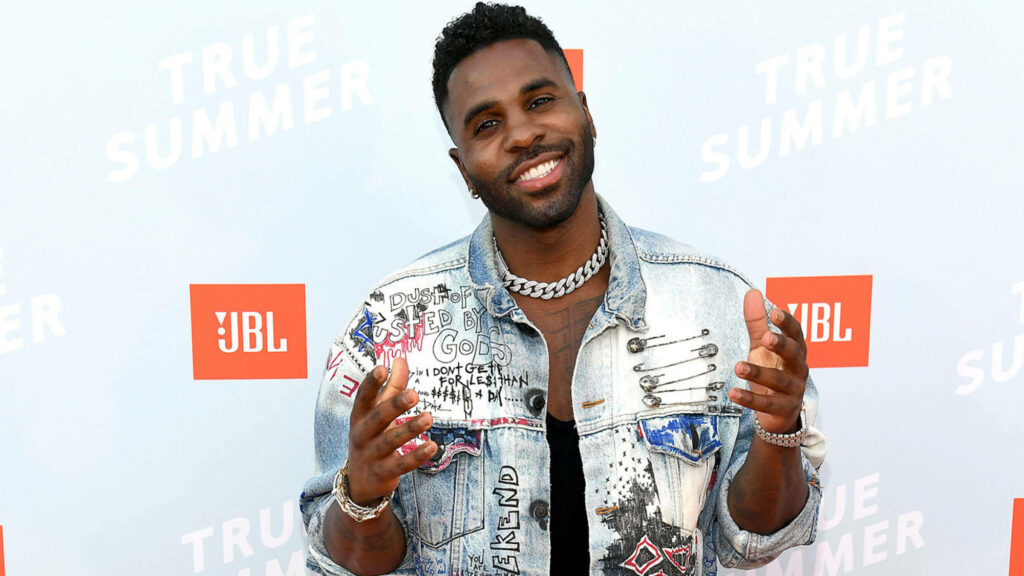 Jason Derulo smiling in denim jacket at JBL event with True Summer and JBL logos background Wallpaper