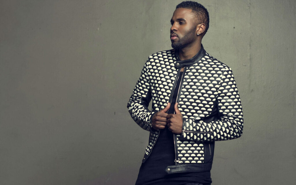 Jason Derulo in stylish patterned jacket gray background confident dapper look wallpaper