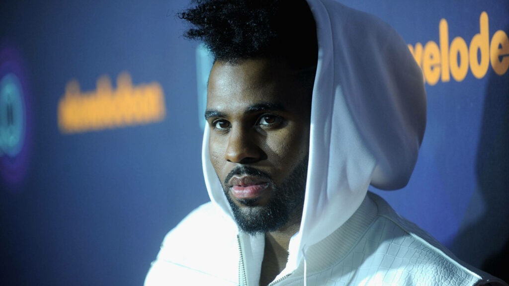 Jason Derulo in white hoodie blue background Nickelodeon event stylish vibrant wallpaper image