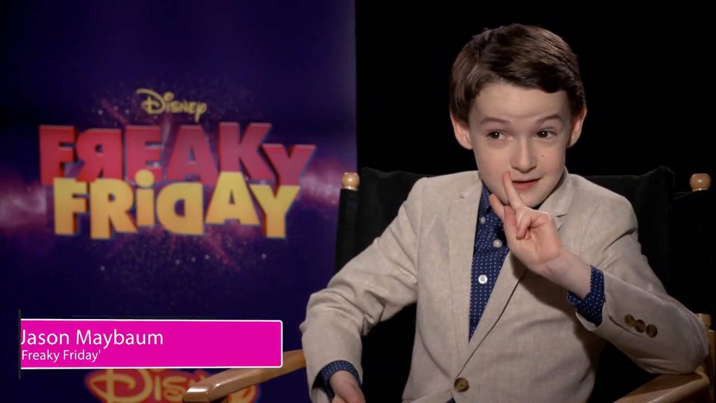 Actor Jason Maybaum in beige blazer at Disney Freaky Friday interview with purple backdrop Wallpaper