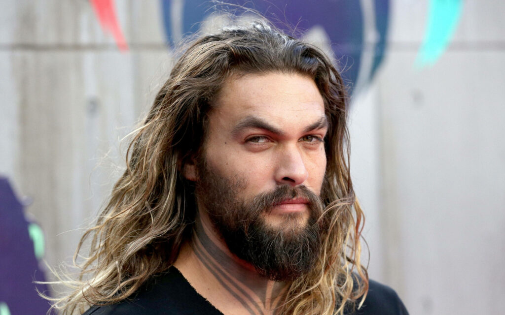 Jason Momoa with long flowing hair and rugged beard strong charismatic portrait wallpaper