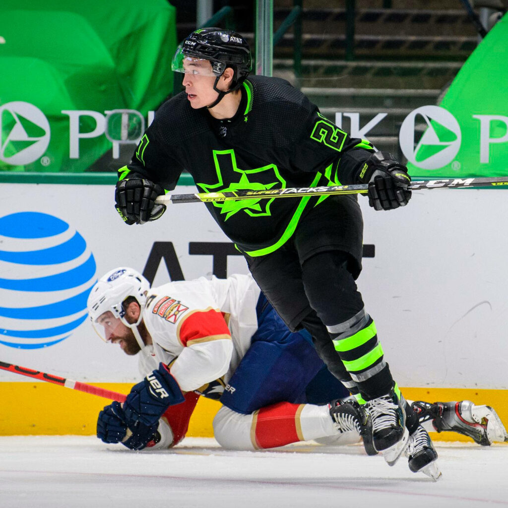 Jason Robertson Dallas Stars leaping in black neon green gear vs New York Islanders NHL action wallpaper