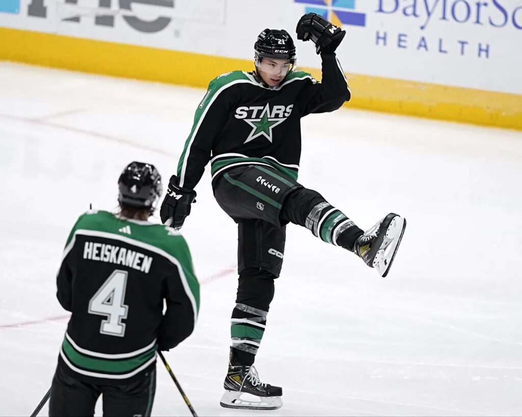 Jason Robertson Dallas Stars celebrating on ice with Heiskanen against Anaheim Ducks rink background Wallpaper