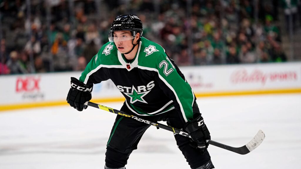 Jason Robertson Dallas Stars in black green uniform focused during NHL game vs Montreal Canadiens Wallpaper
