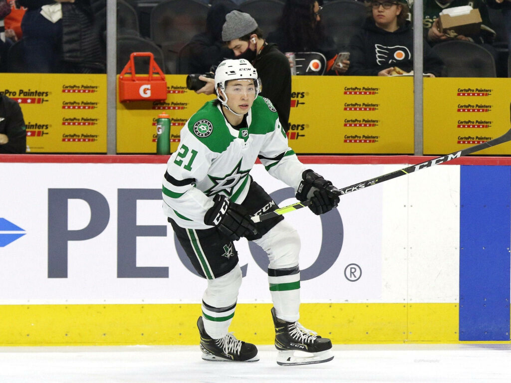 Jason Robertson Dallas Stars in white green uniform focused on ice during NHL game action wallpaper