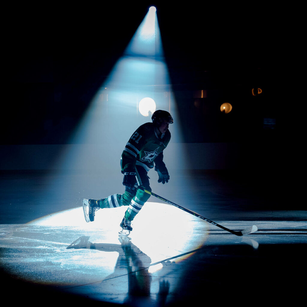 Jason Robertson Dallas Stars in green black uniform spotlight ice hockey intense action wallpaper