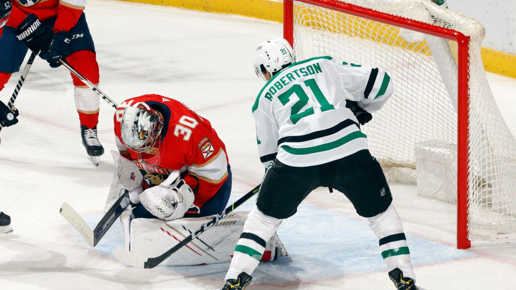 Jason Robertson in Action: Intense Hockey Match Wallpaper Background