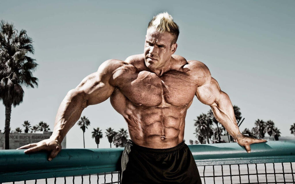 Jay Cutler muscular bodybuilder posing outdoors with palm trees clear sky wallpaper background