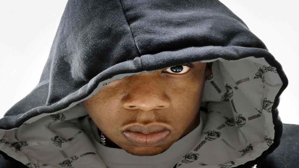 Jay-Z close-up portrait wearing dark hoodie with intense expression on light background wallpaper