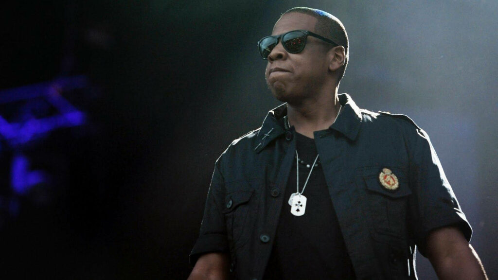 Jay-Z on stage wearing sunglasses and dark jacket iconic American rapper and record producer Wallpaper