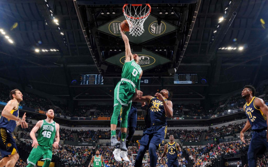 Jayson Tatum dunking over Myles Turner in intense Celtics vs Pacers NBA game action wallpaper