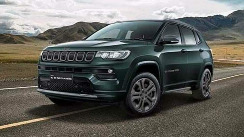 Jeep Compass driving on open road with rugged mountain background outdoor adventure wallpaper