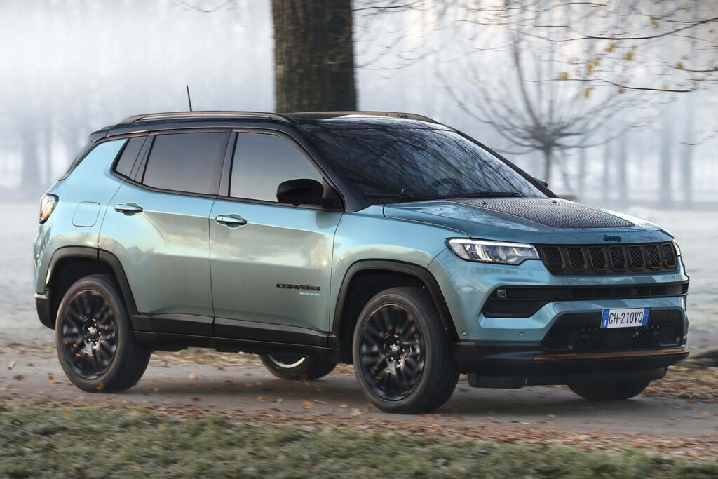 Jeep Compass driving through snowy forest showcasing rugged capability and sleek modern design Wallpaper