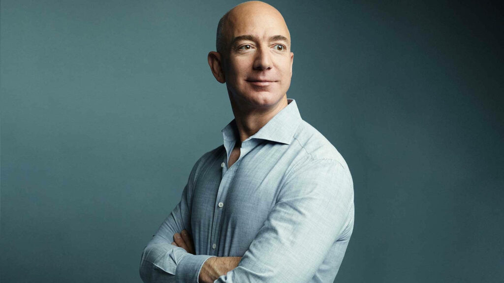 Confident Jeff Bezos Side-View Portrait in Light Blue Shirt - Wallpaper