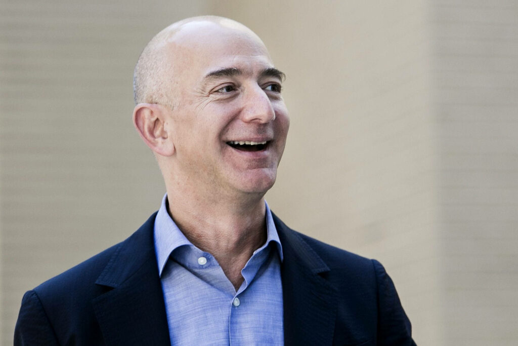 Portrait of Jeff Bezos Smiling with Blurred Wallpaper Background