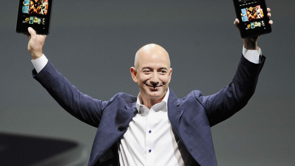 Professional Wallpaper of Jeff Bezos with Devices on Dark Background