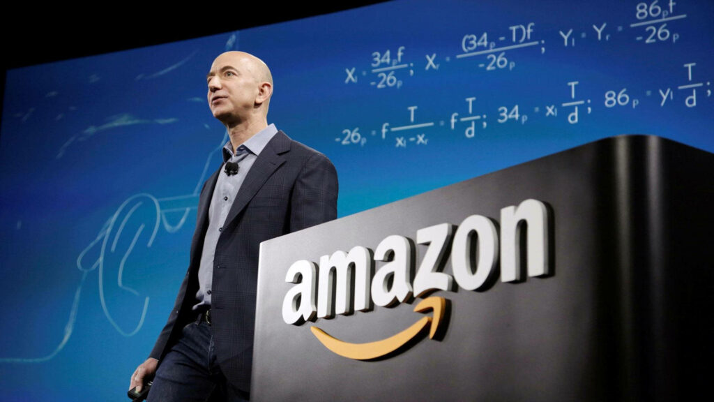 Jeff Bezos at Podium: Amazon Presentation with Equation Wallpaper