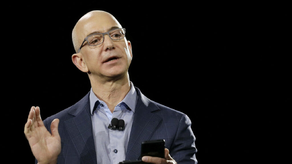 Jeff Bezos Wallpaper: Professional Suit, Eyeglasses & Audience Engagement