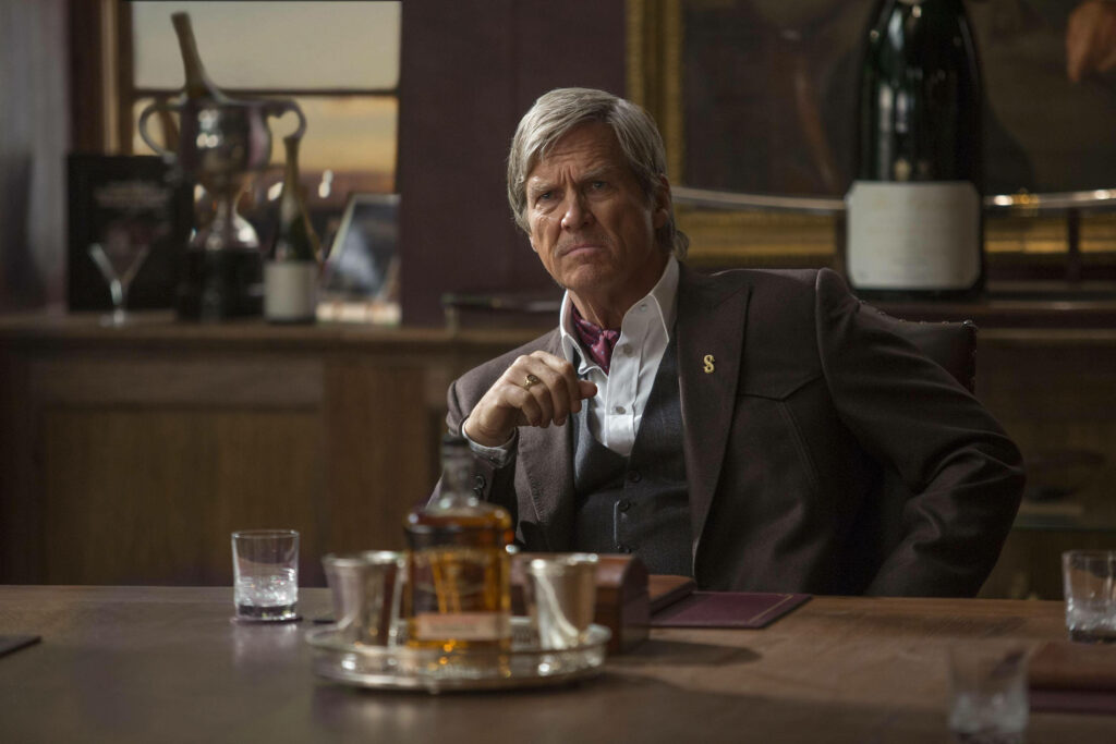 Jeff Bridges at elegant bar in sharp Kingsman suit exuding charismatic refined style wallpaper