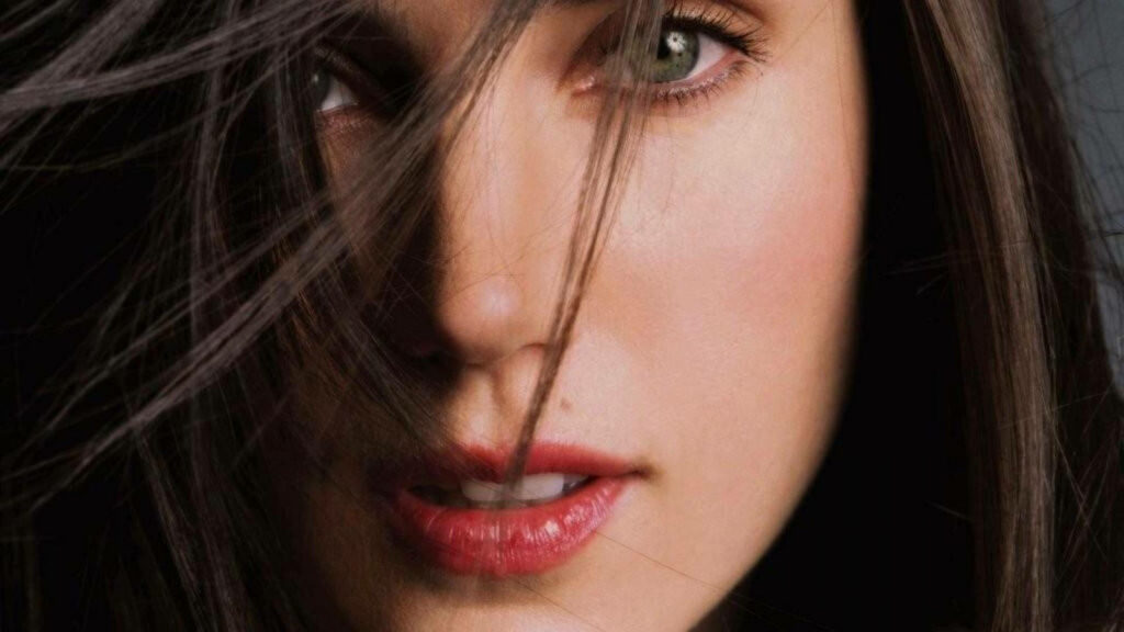Close-up of Jennifer Connelly with expressive green eyes and soft features dark flowing hair wallpaper