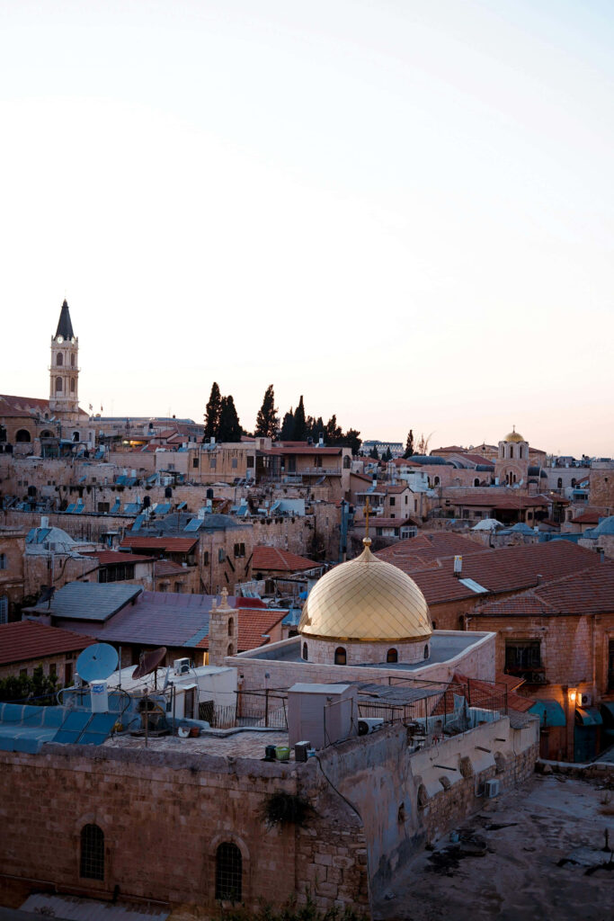 Jerusalem skyline at dusk with golden dome ancient rooftops and modern buildings wallpaper