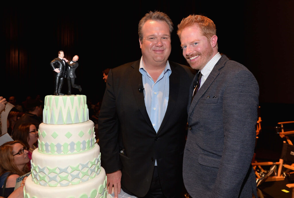 Jesse Tyler Ferguson and Eric Stonestreet in formal wear at Modern Family event with character cake Wallpaper