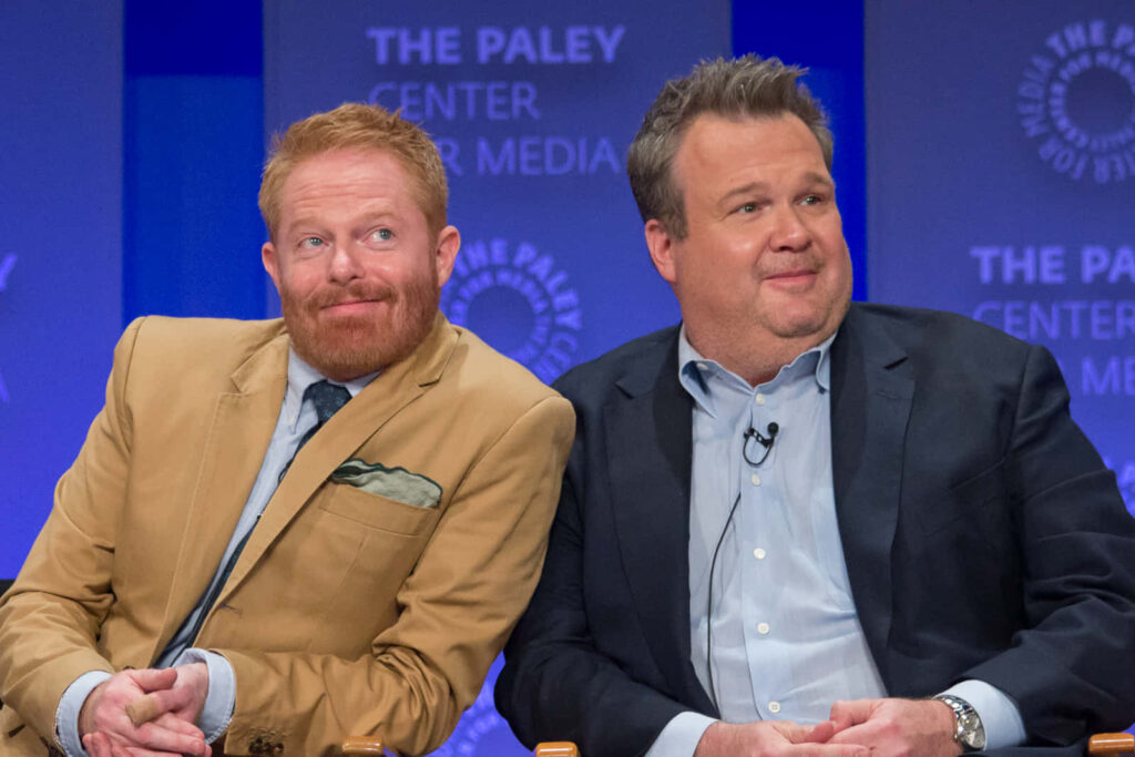 Jesse Tyler Ferguson and Eric Stonestreet in formal suits at PaleyFest 2015 with Paley Center logo background Wallpaper