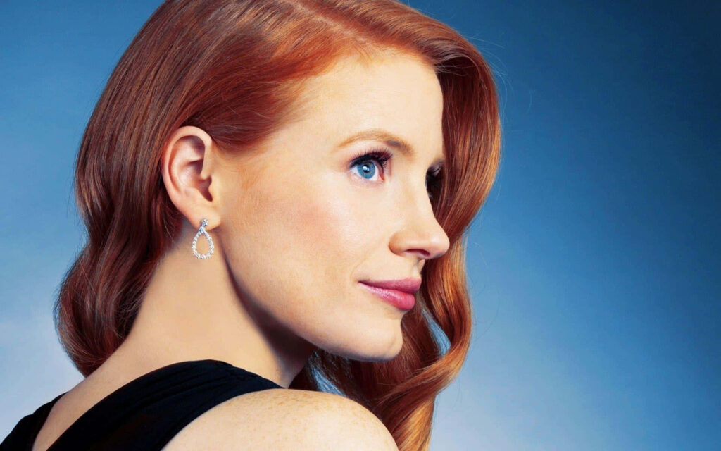 Jessica Chastain elegant profile portrait on soft blue background wallpaper for desktop