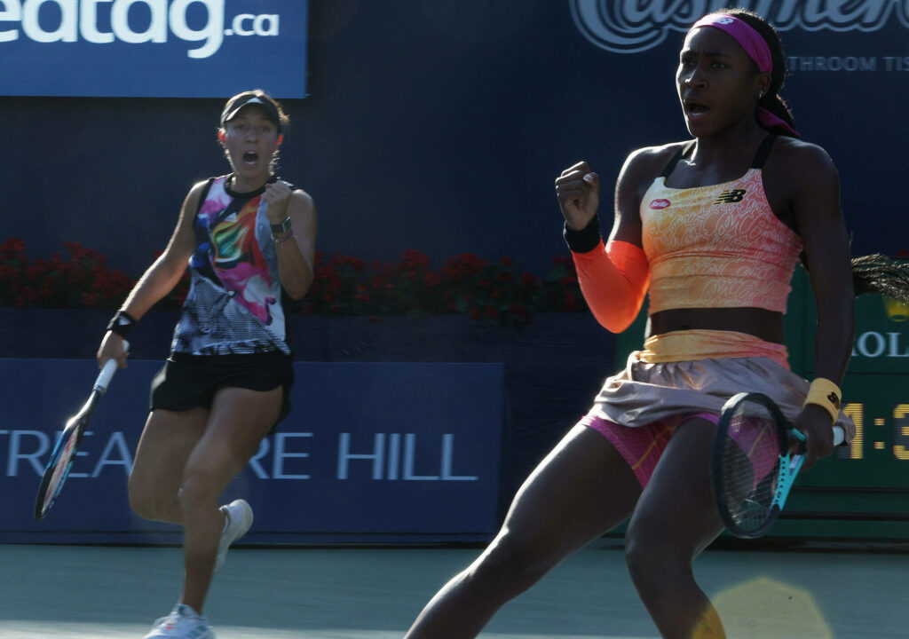 Jessica Pegula and Coco Gauff fist pump celebrating intense tennis match teamwork and energy Wallpaper