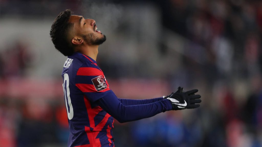 USMNT forward Jesus Ferreira in navy red kit during cold intense World Cup qualifier action Wallpaper